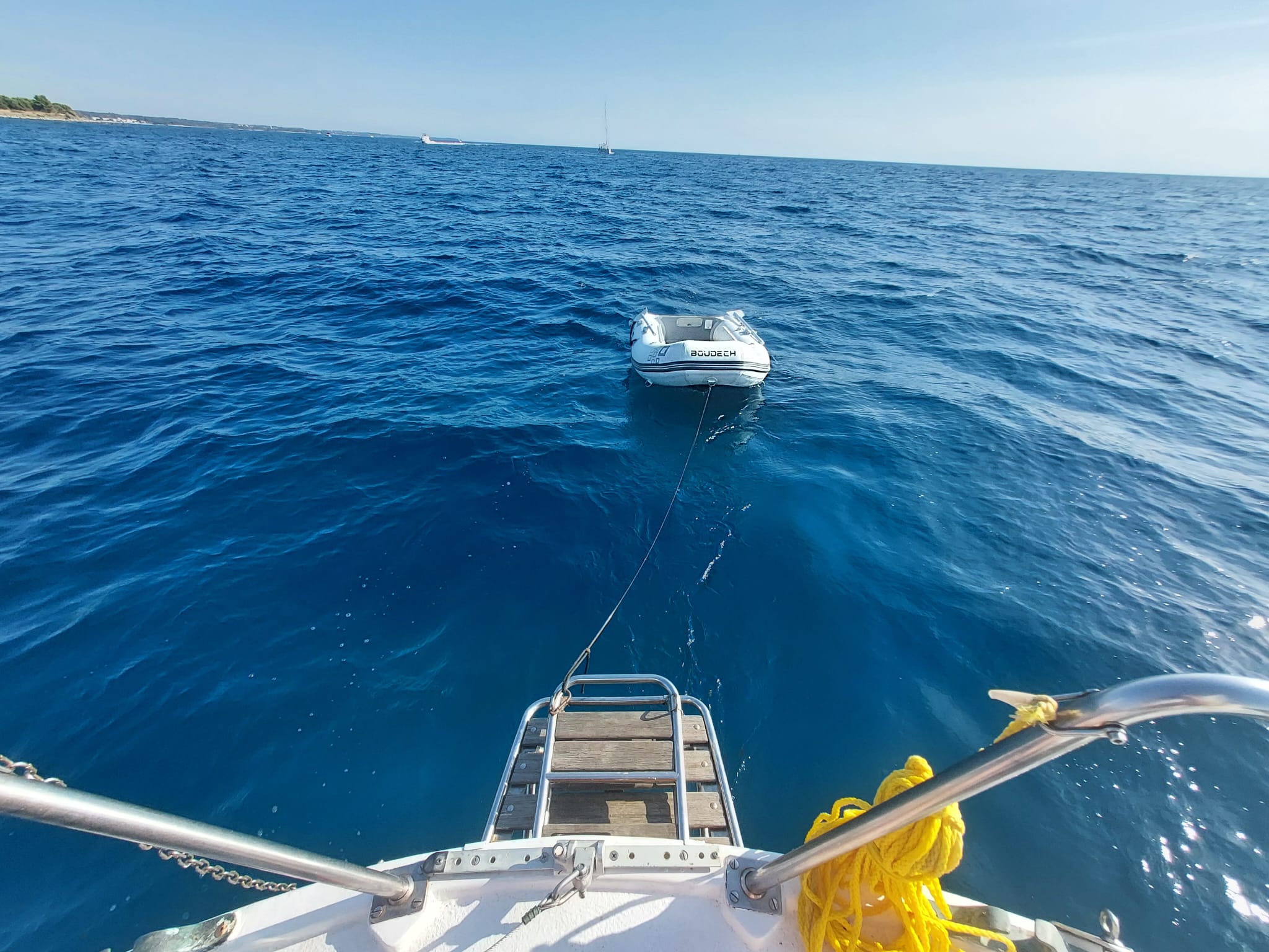 STRIGA's swim platform with the tender floating on a rope behind, calm blue water